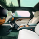 The rear seating area of a Bentley Bentayga EWB in green and tan leather.